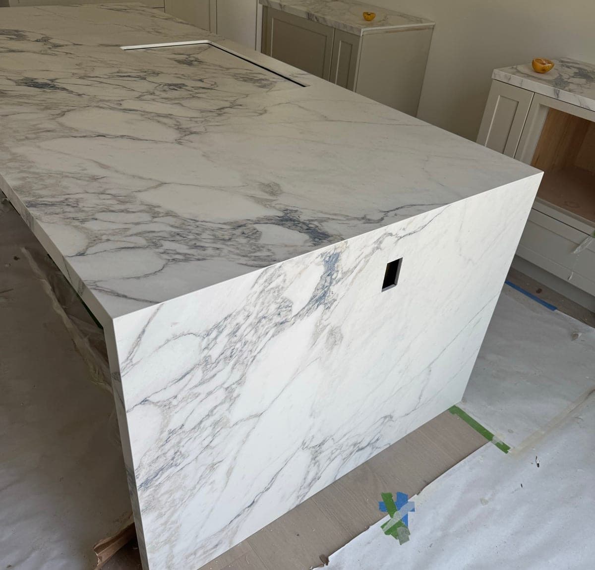 Mitred waterfall edge on a quartz island, veining carried over the corner
